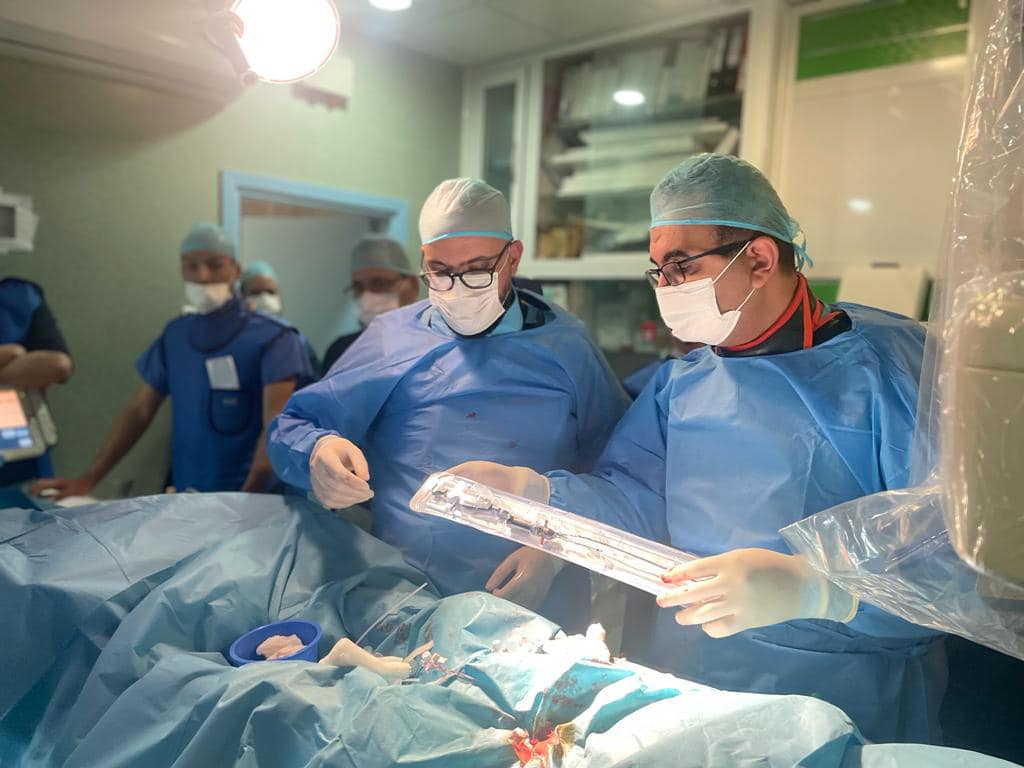 Doctors at Al-Khadra Hospital perform an operation to implant aortic valve through a catheter. 