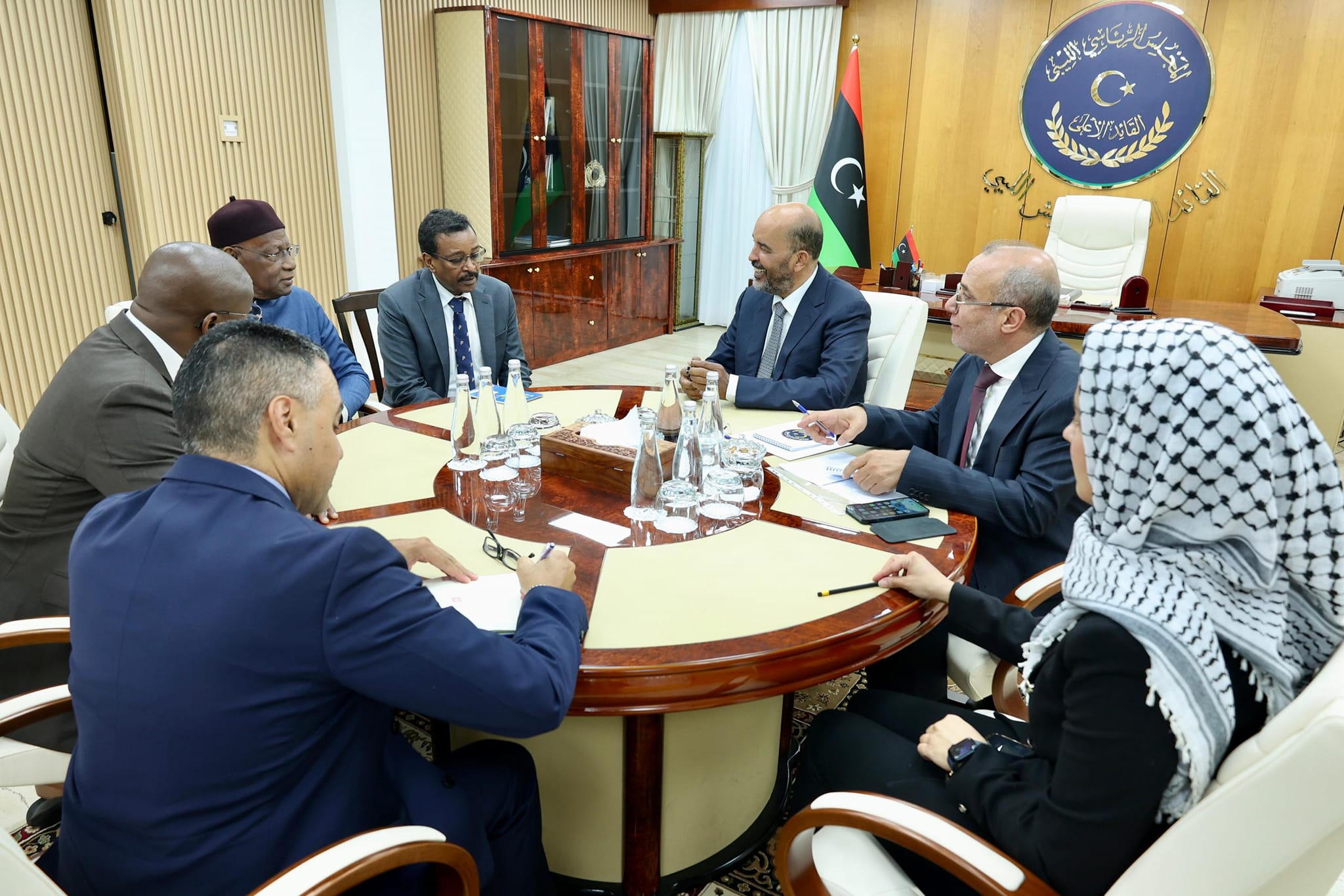 Musa Al-Koni and Abdullah Al-Lafi receive Abdullah Batili before handing over his duties.