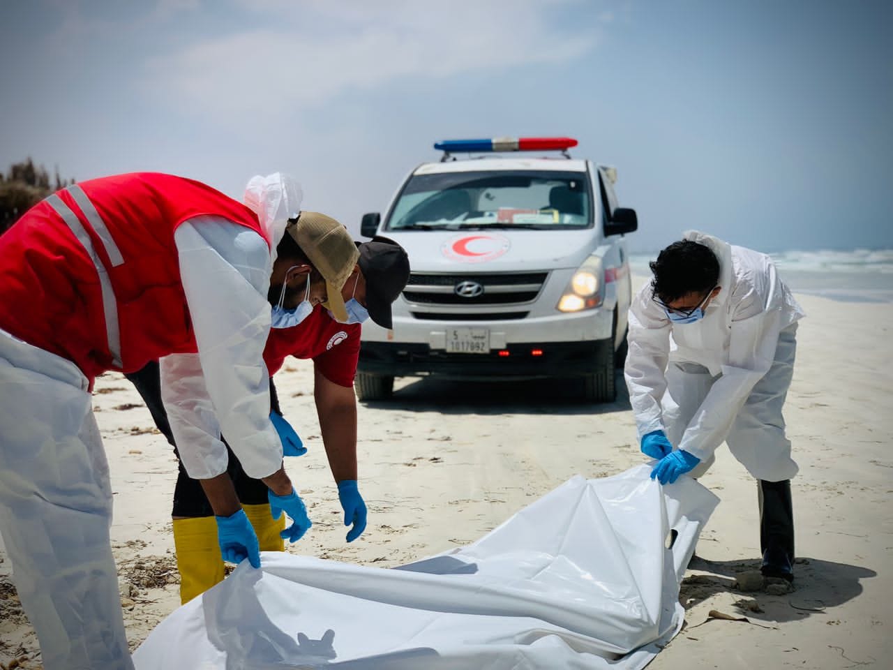 Recovering six bodies at Sabrata beach.